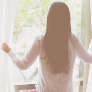 woman looking out the window