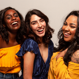 three woman laughing and enjoying each other's company