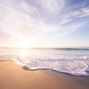 Picture of the beach with sun in the background