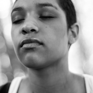 black and white image of a woman with her eyes closed