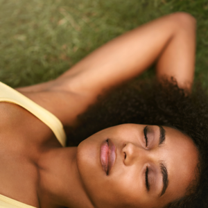 a woman laying down on the grass resting