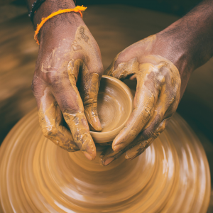 A woman molding clay