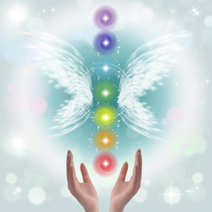 A woman hand opened up with chakra stones in the air between butterfly wings