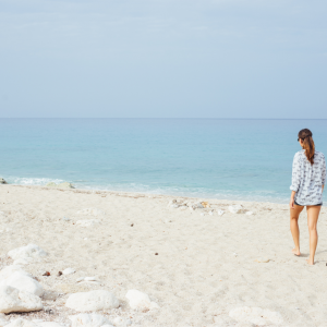 A woman taking a long walk on the beach