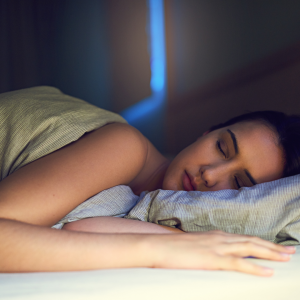 A woman laying down on with the sunrise peaking through the window
