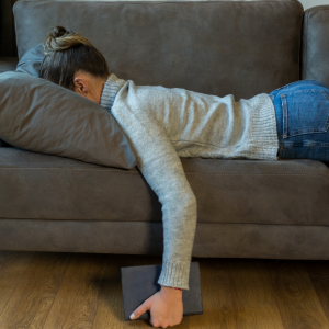 A woman planted face first into her sofa exhausted