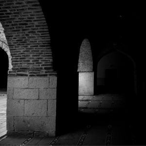 A black and white image of an abandoned hallway