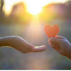 A child giving a older woman a heart