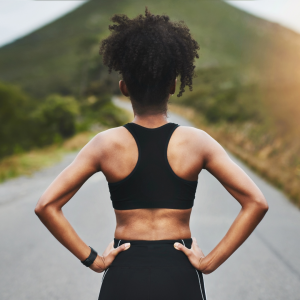 A woman finishing successful run looking onto the open road